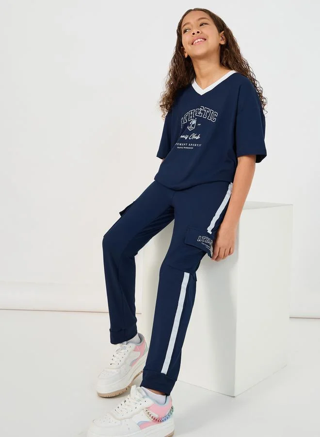 Styli Graphic Print V-Neck T-Shirt And Tape Detail Cargo Joggers Co-Ord Set (Unisex, Premium Cotton Blend) mcne4
